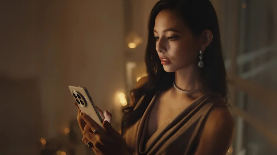 Žena drží telefon OnePlus 13 5G ve tmě, displej svítí, zdůrazňující funkci Eye Care displeje.